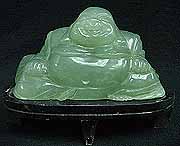 BURMA JADE SITTING BUDDHA (LH001)
This sitting buddha is made from Burma Jade. One solid piece. It comes with a wooden stand. Very detailed carving. 
Size: L:7 in, W: 3 in, H: 5 in 
